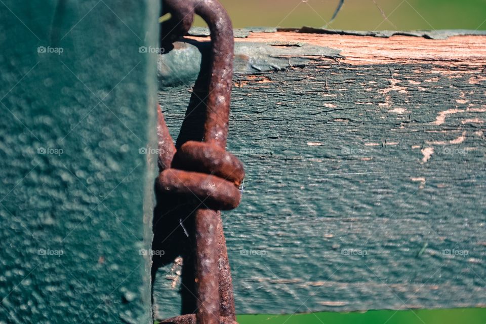 Rusted iron hook on old weathered wood grunge background image