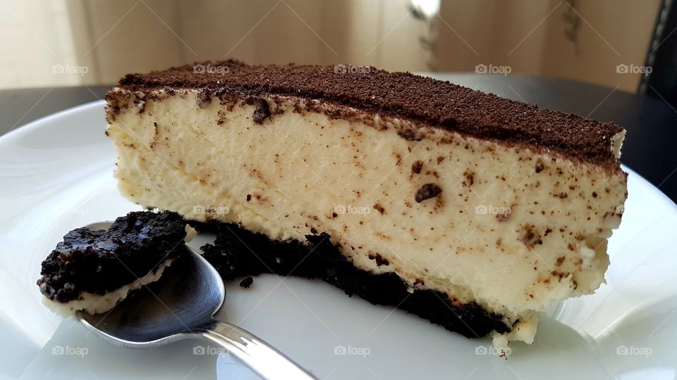 tasty and sweet cake with dark cookies