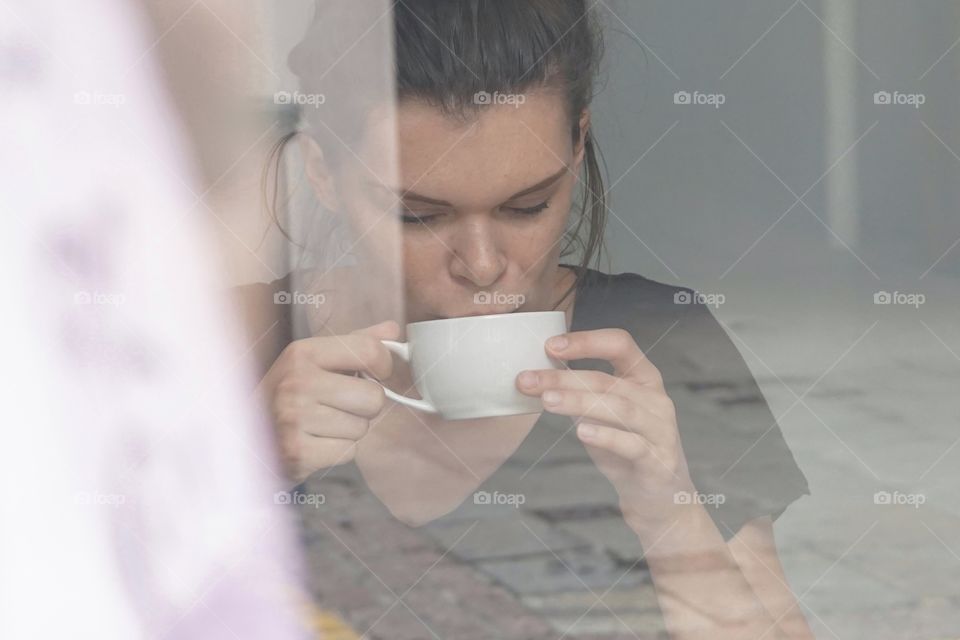 Happiness is .. a cup of tea ... taken through a shop window .. this is the Manageress modelling for me we tried an arty slant for the photo shoot through her shop window ... 