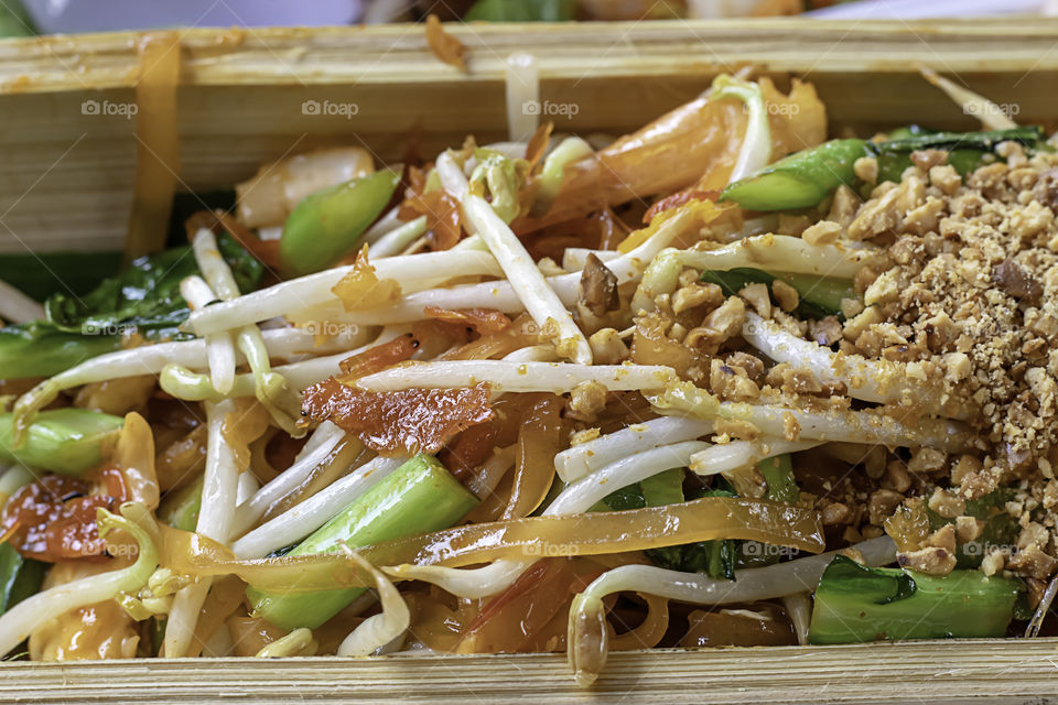 Fried noodle with spring onion and bean sprouts in bamboo.