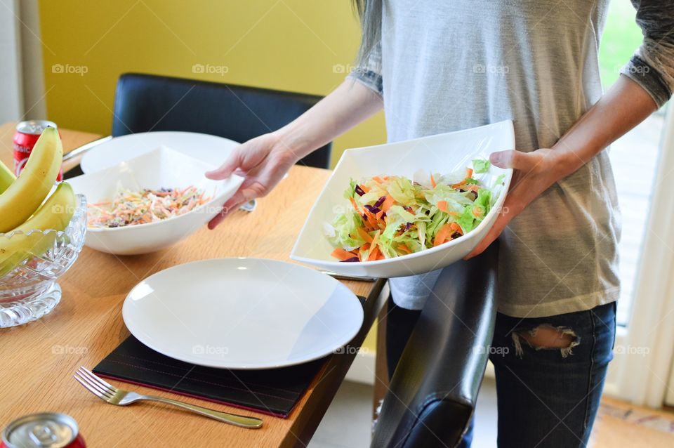 Person holding foods in bowl