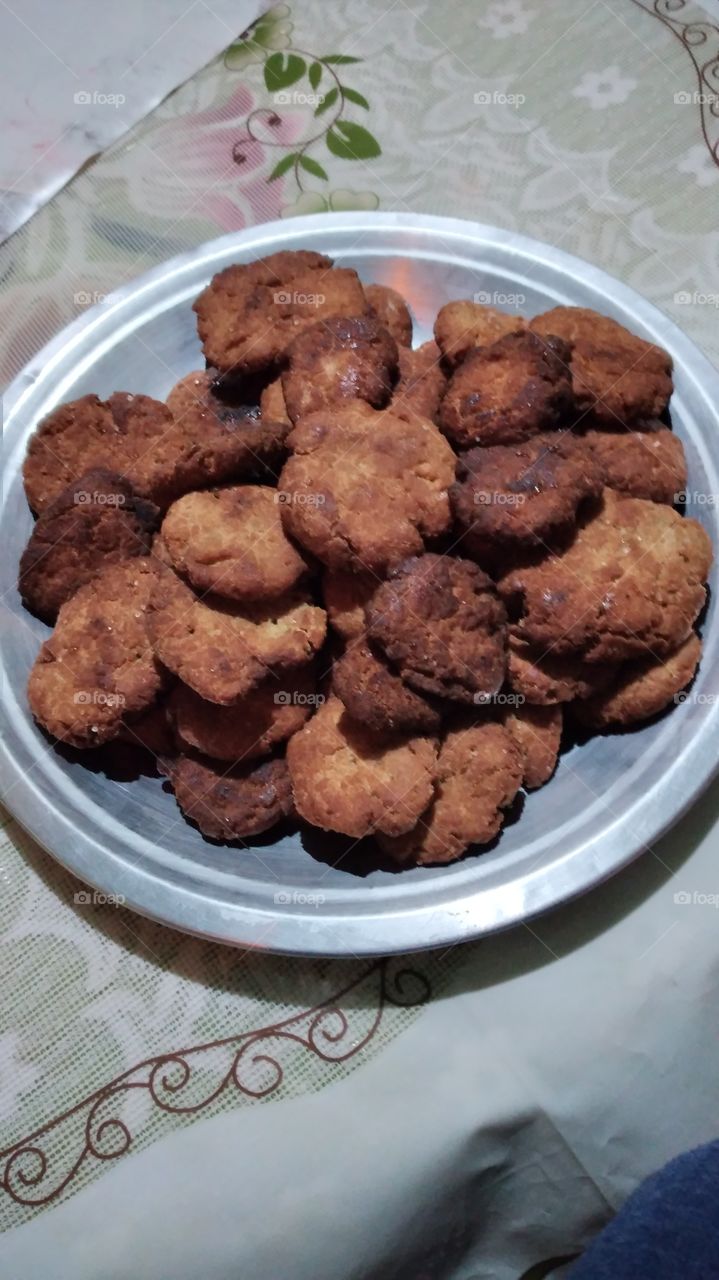 A plate of homemade sweet cakes or Indian Thakua , a delicious  food  made of banana, coconut ,sugar,wheat and fried in a  pan.
