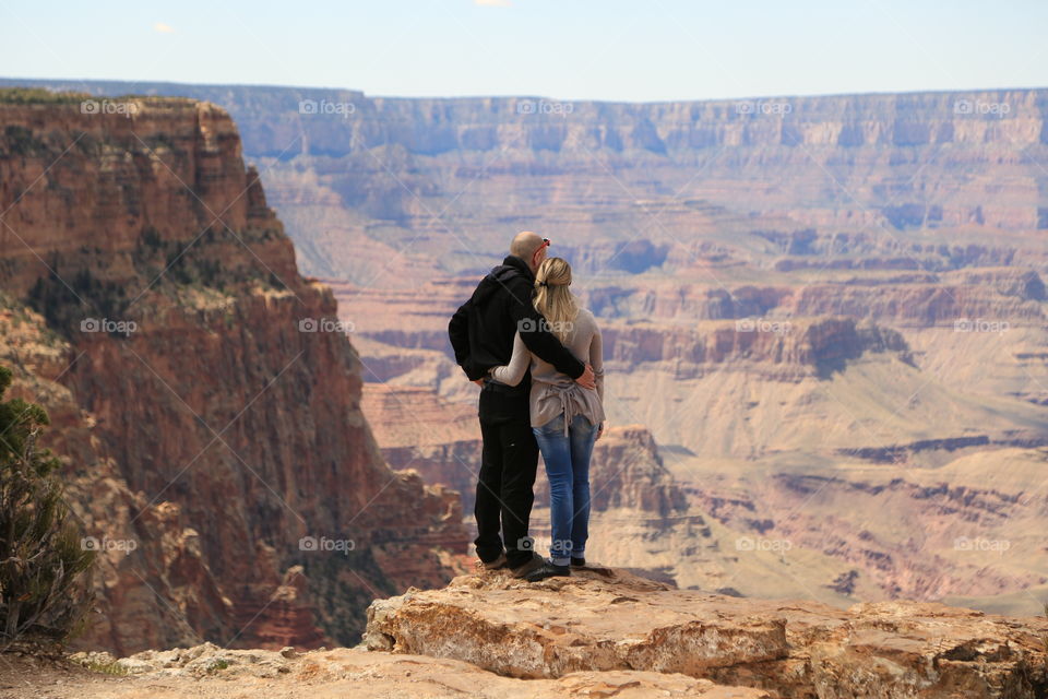 Couple enjoying each other looking over the Grand Canyon