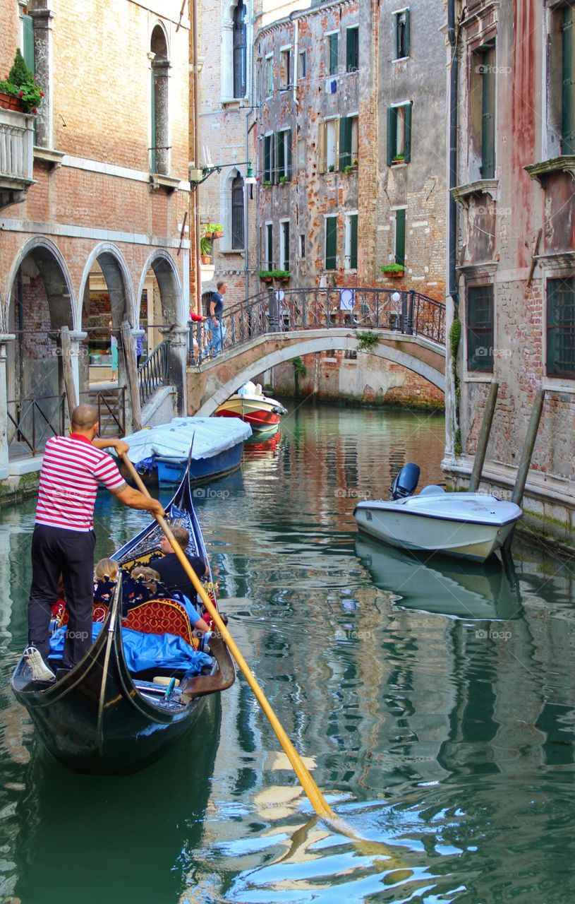 Gondolier. Visitors to Venice take a gondola trip