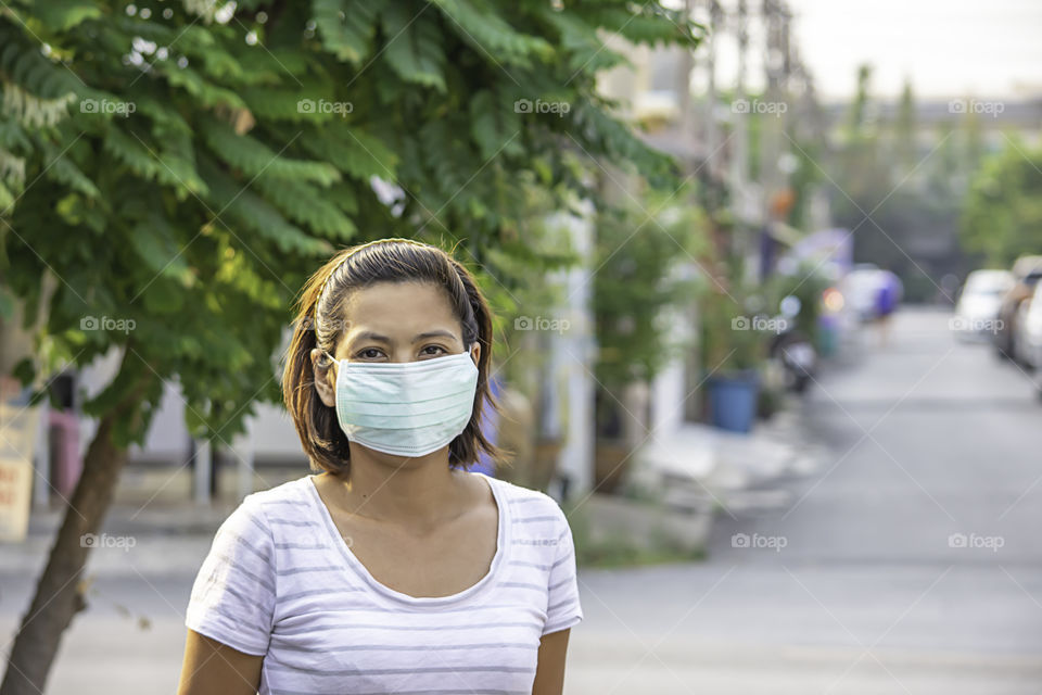 Asean Woman wear a mask to prevent dust in Bangkok ,Thailand.