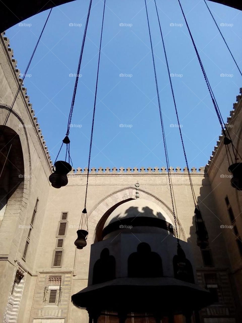 Ancient building and some lamps hanging with blue sky background 