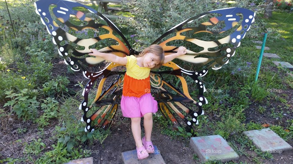 Girl sitting on butterfly seat