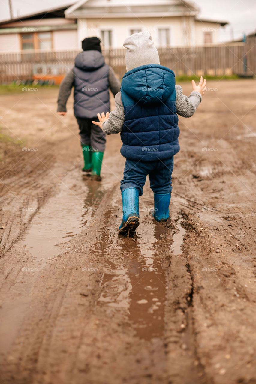 children run in puddles