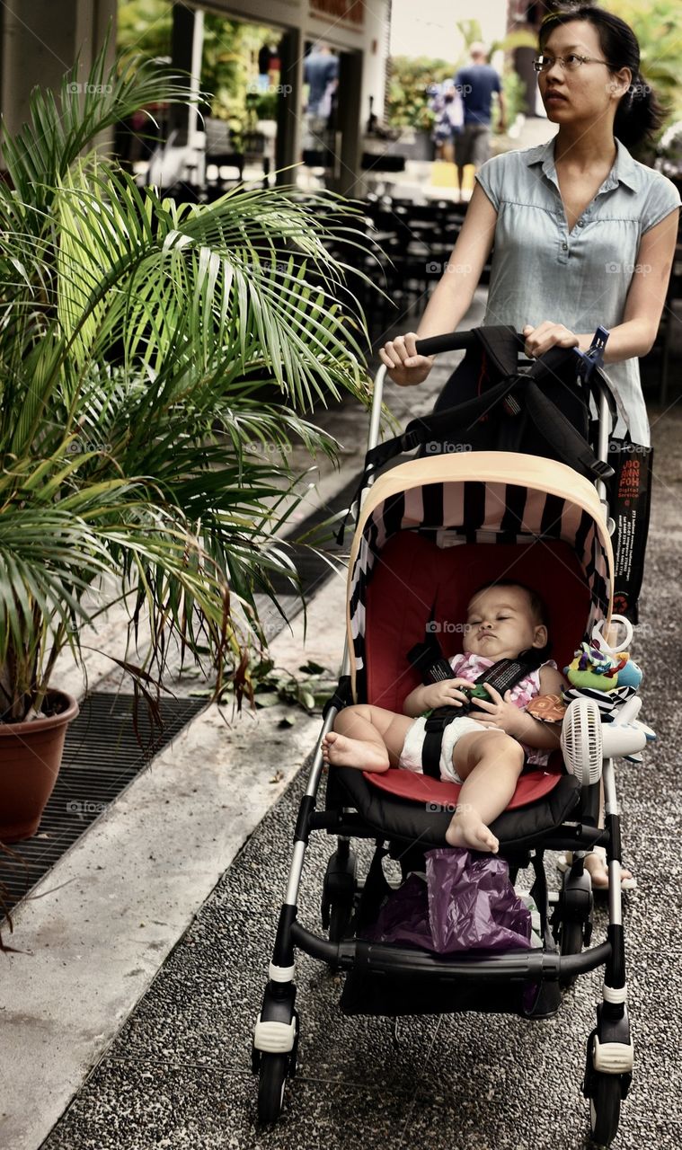 Mother walking with baby in stroller