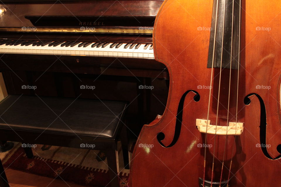 Double bass and piano. . A double bass and piano in one frame.