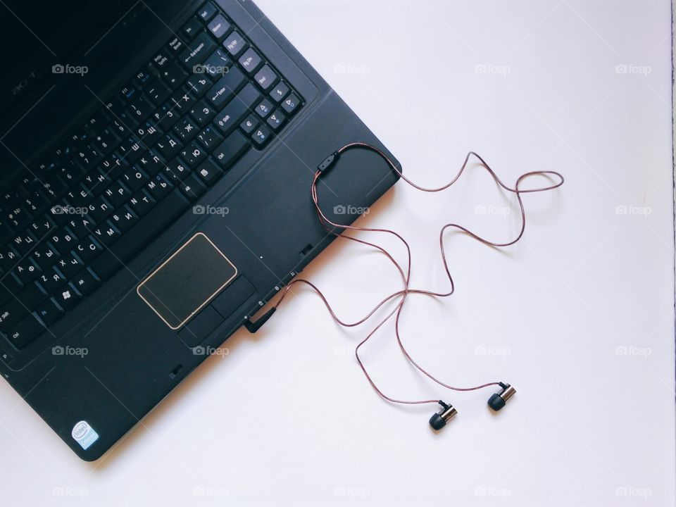 Laptop and audiophile headphones on a white background