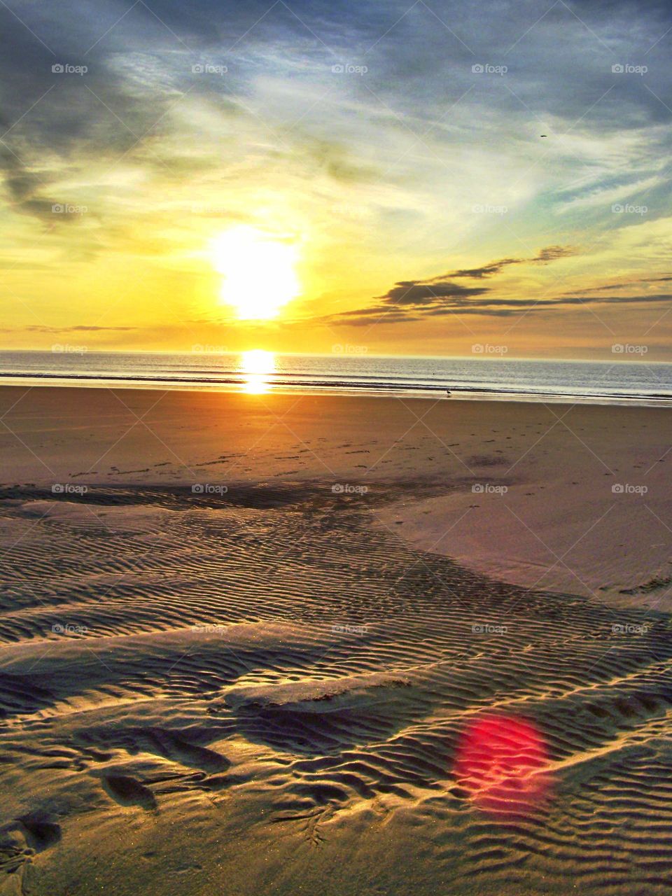 The Sun Shines Alone. Beautiful sunrise on an unoccupied beach. Solitude.