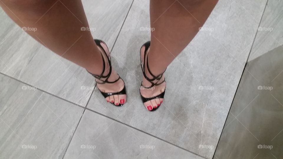 Classic red toes and sexy black heels makes a lady stand proud