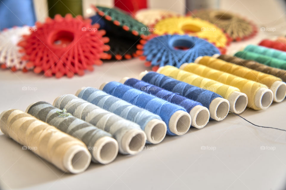 Multi-colored spool arranged in a row