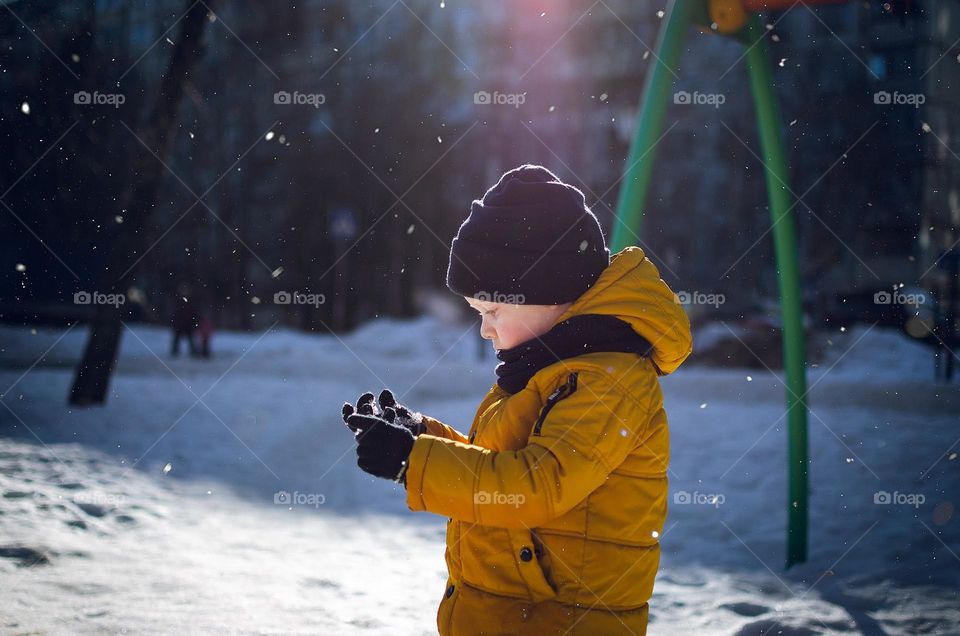 Boy in a yellow coat.