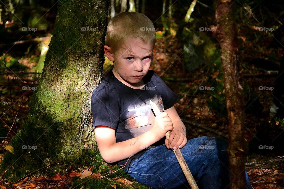 Boy playing in the forest