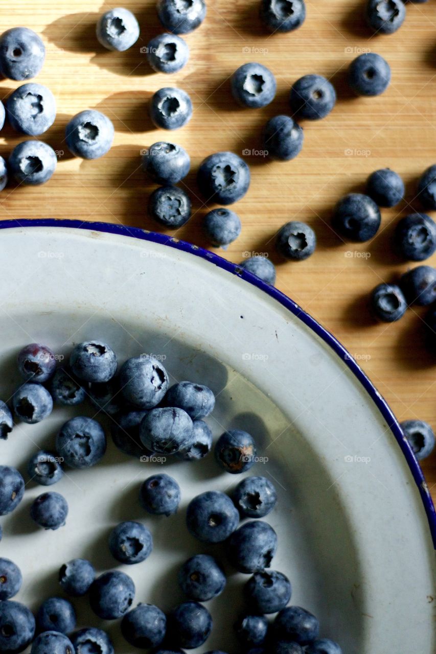 Fruits! - Blueberries on a vintage enamel plate on bamboo in natural light