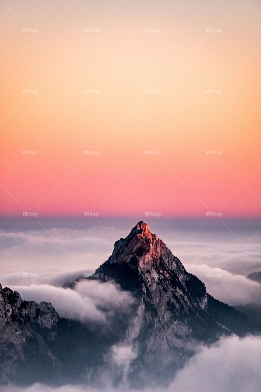 Mountain and clouds match the natural landscape of the sunset