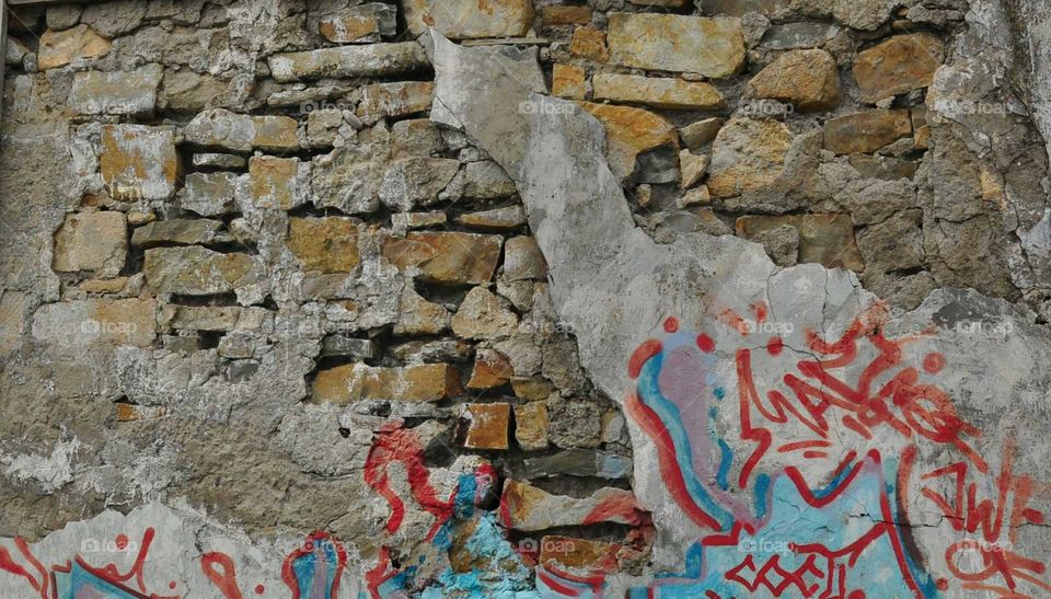 Graffiti over old stone wall
