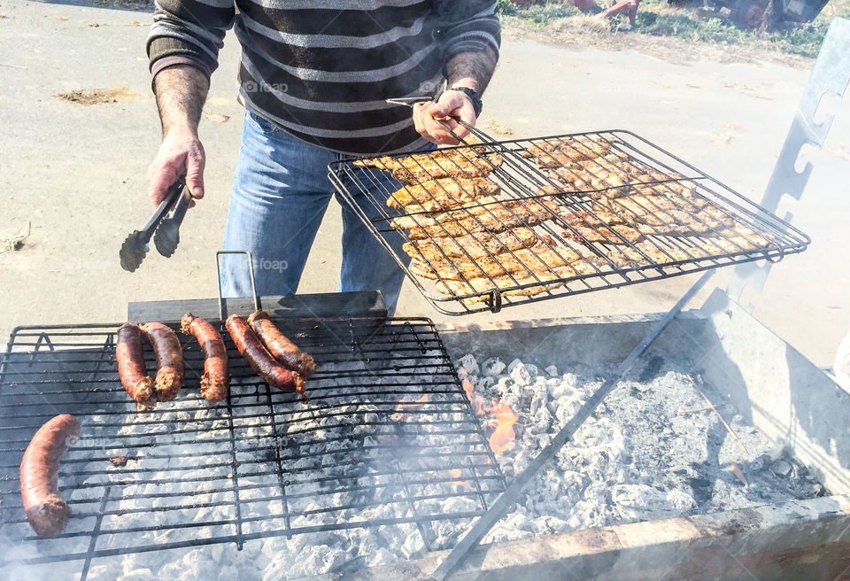 A person cooking sausage