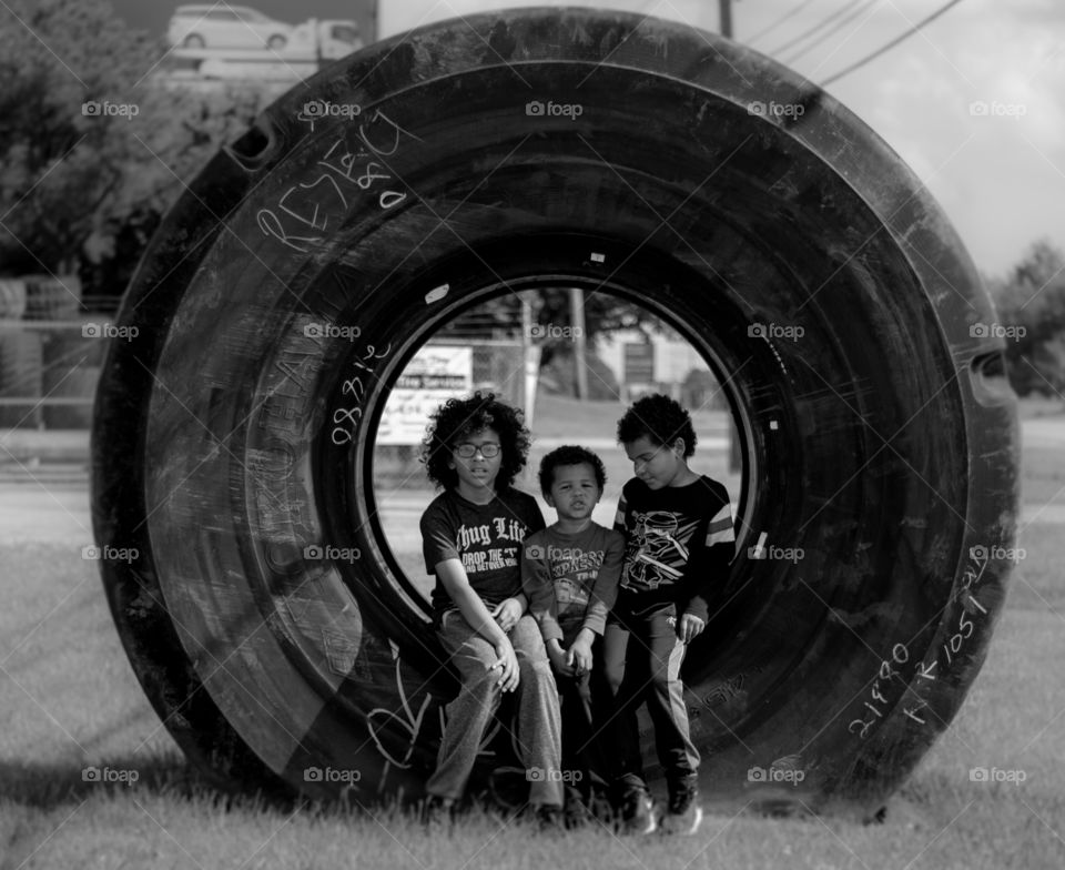 Three brothers find an oversized tire