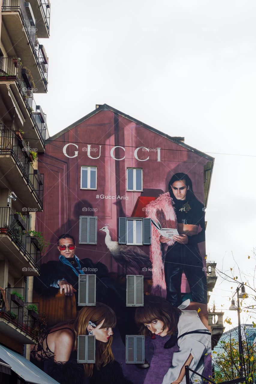 Milan, Italy Colorful wall graffiti by Gucci fashion brand. Vibrant street art mural depicting Eurovision winners band Maneskin, part of the Gucci Aria collection campaign.