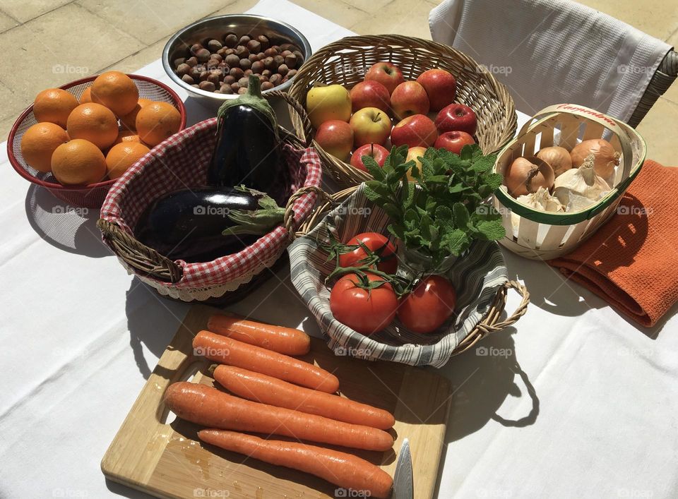 Back from the market : fresh vegetables and fruits in green baskets with natural materials 