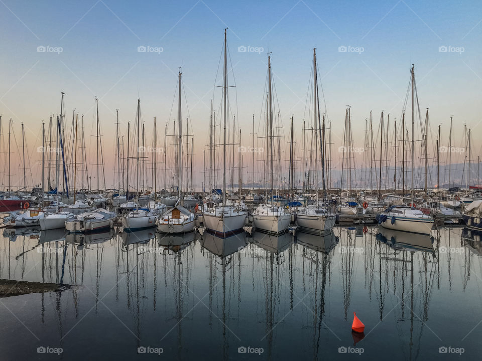 Sail boat reflecting on sea