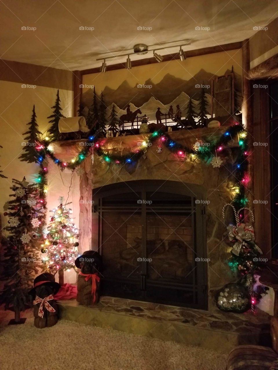 fireplace decorated for Christmas with garlands and lights, western theme