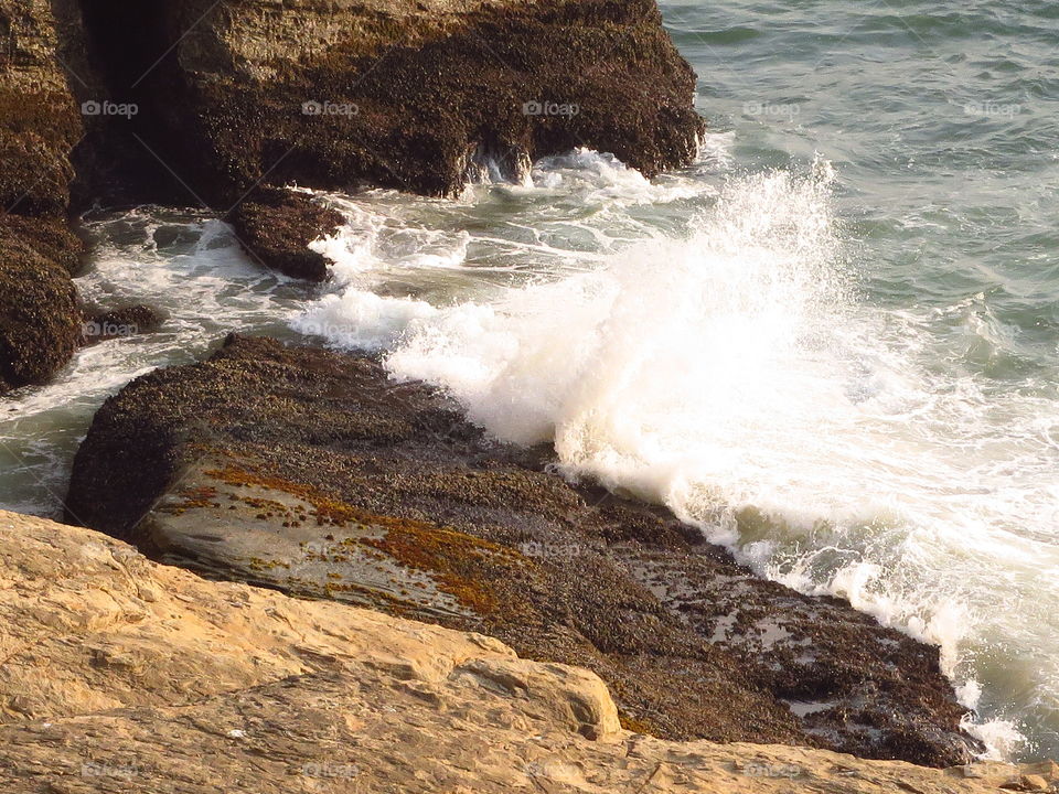Waves splashing at coastline