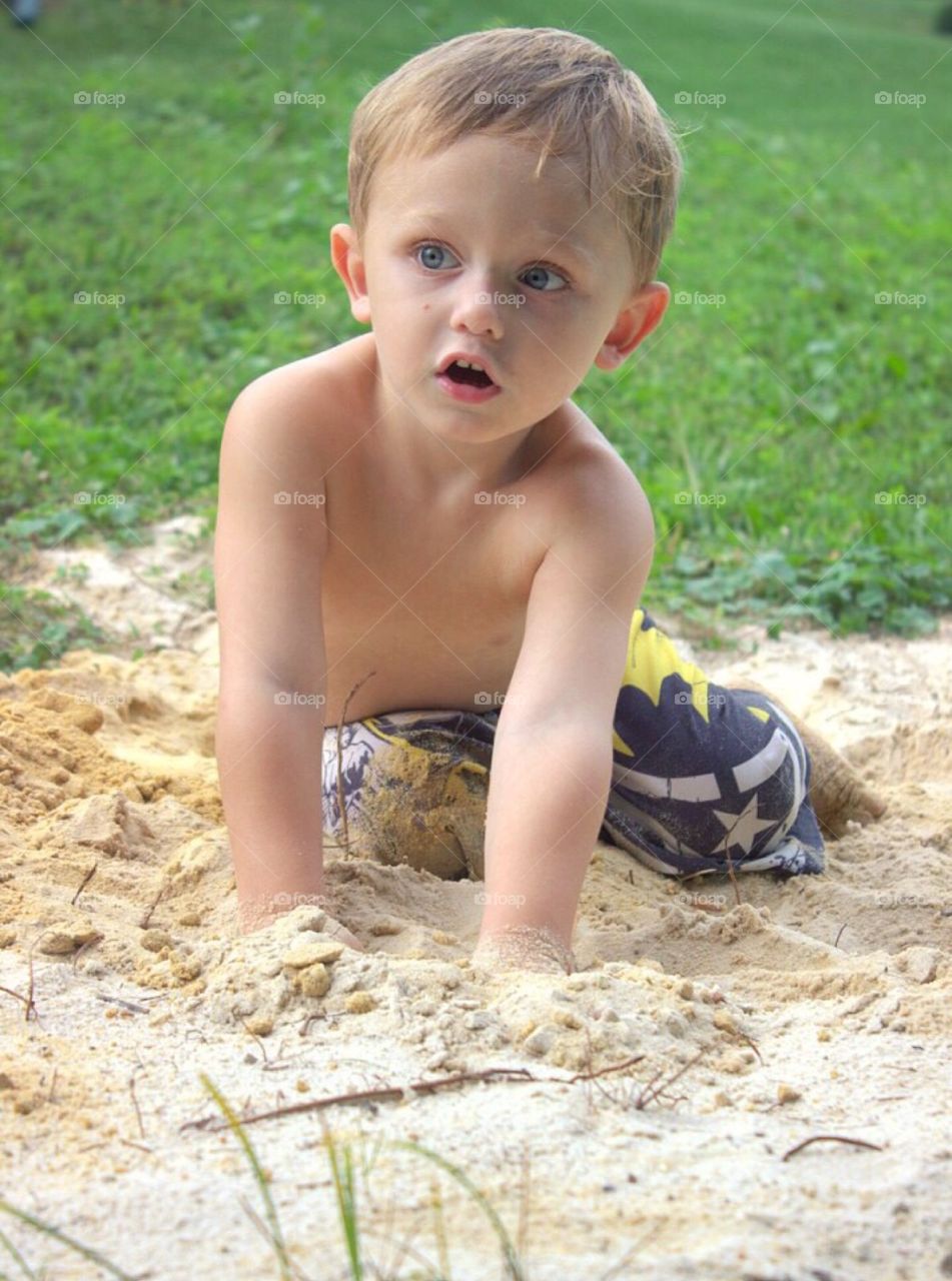 Portrait of a boy playing in sand