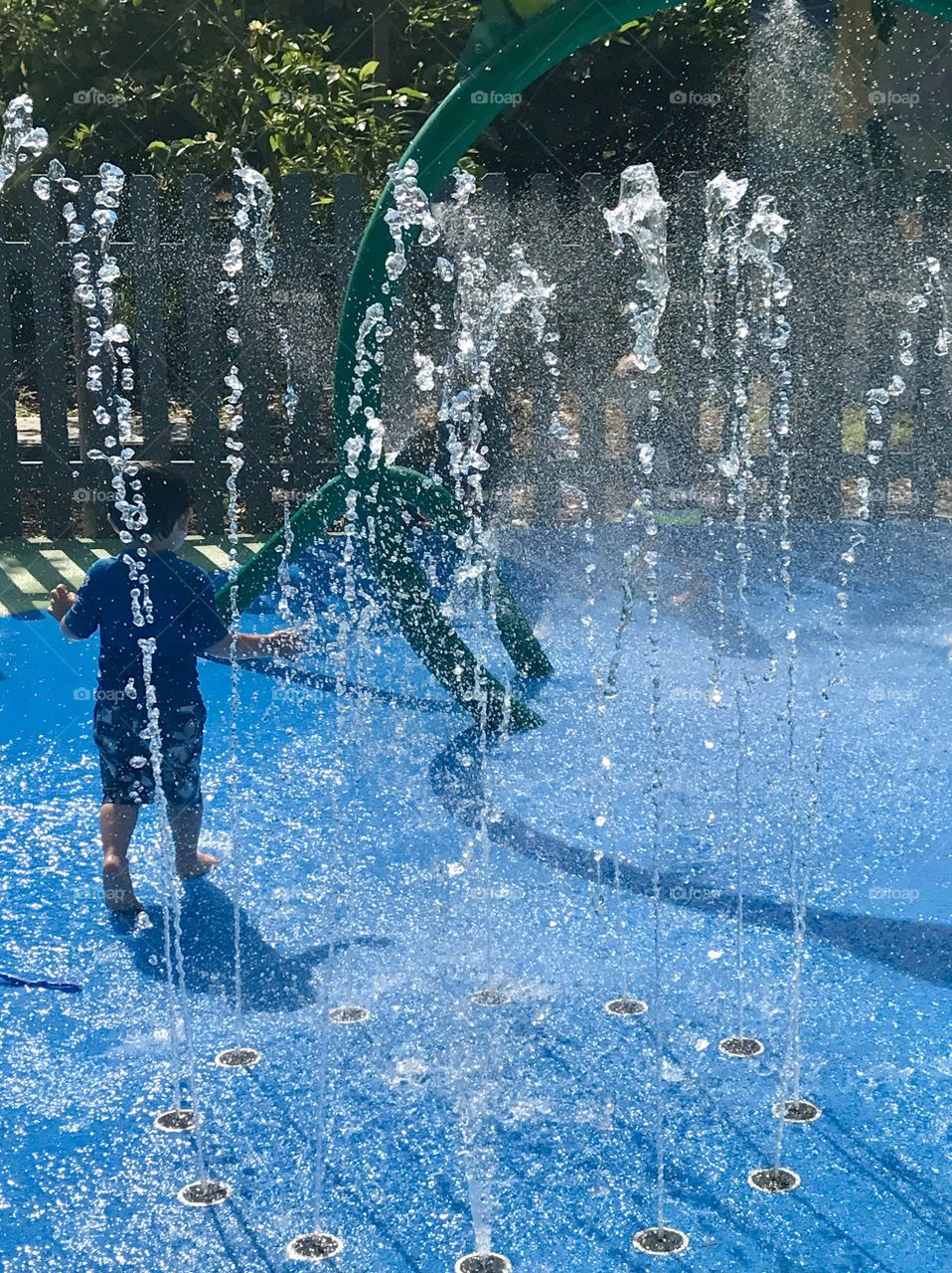 Boy splashing through water