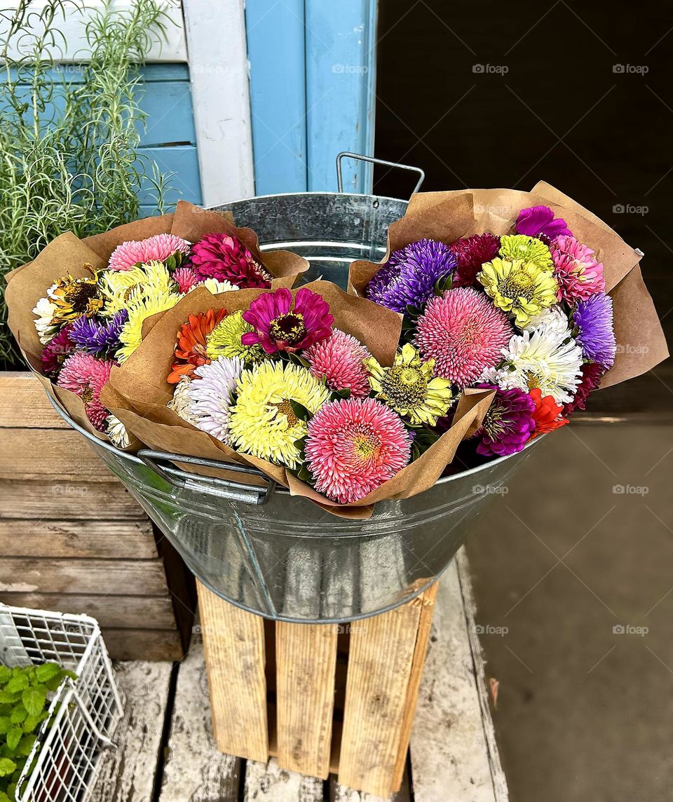 Autumn bouquet of flowers in an iron bucket
