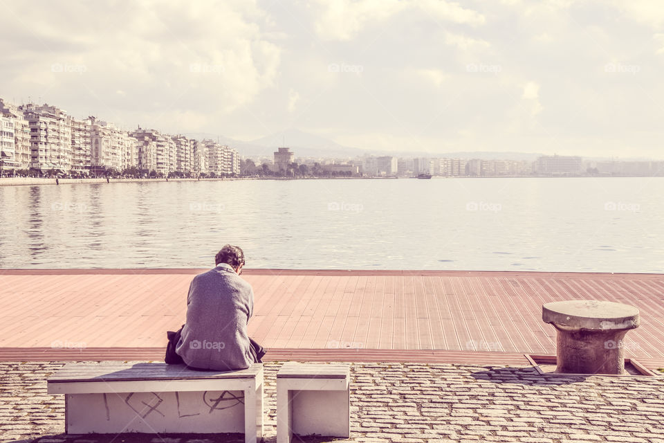 Man Sitting Alone At The Dock And Enjoying The View
