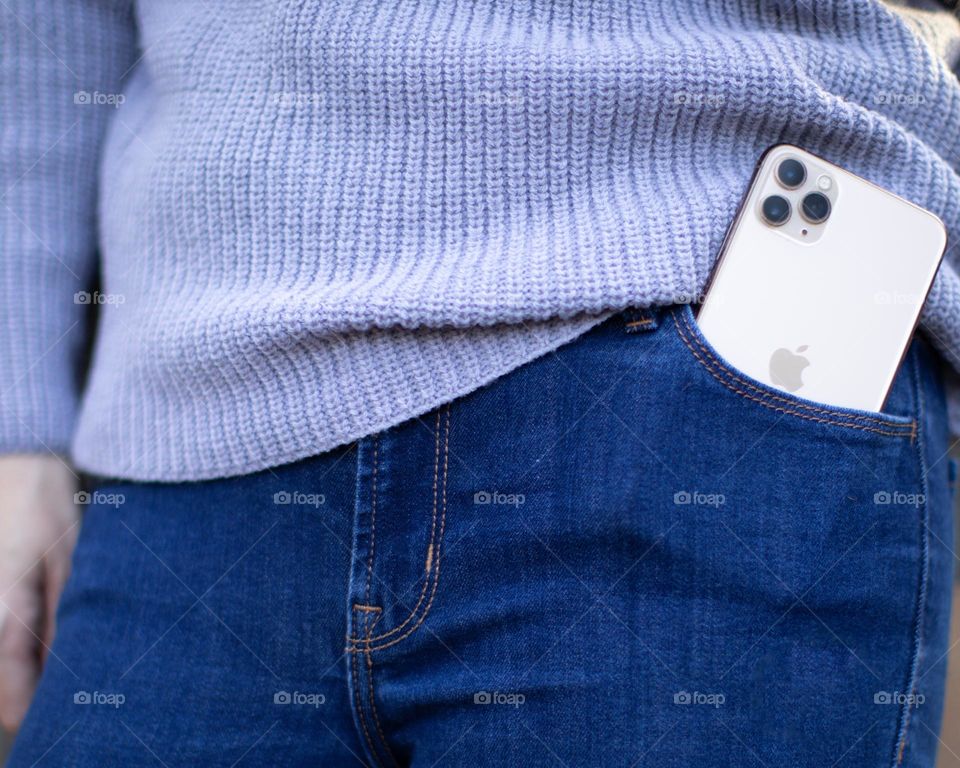 Apple; Woman in fall attire with iphone in pocket