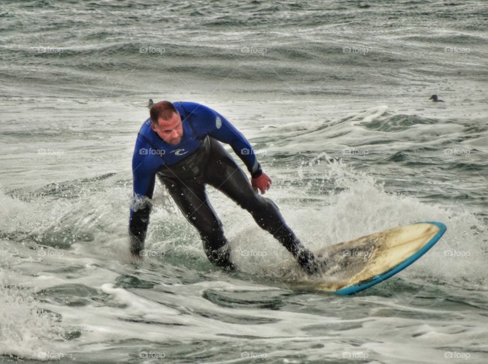 Big Guy Riding A Surfboard. Big Guy Catching A Wave