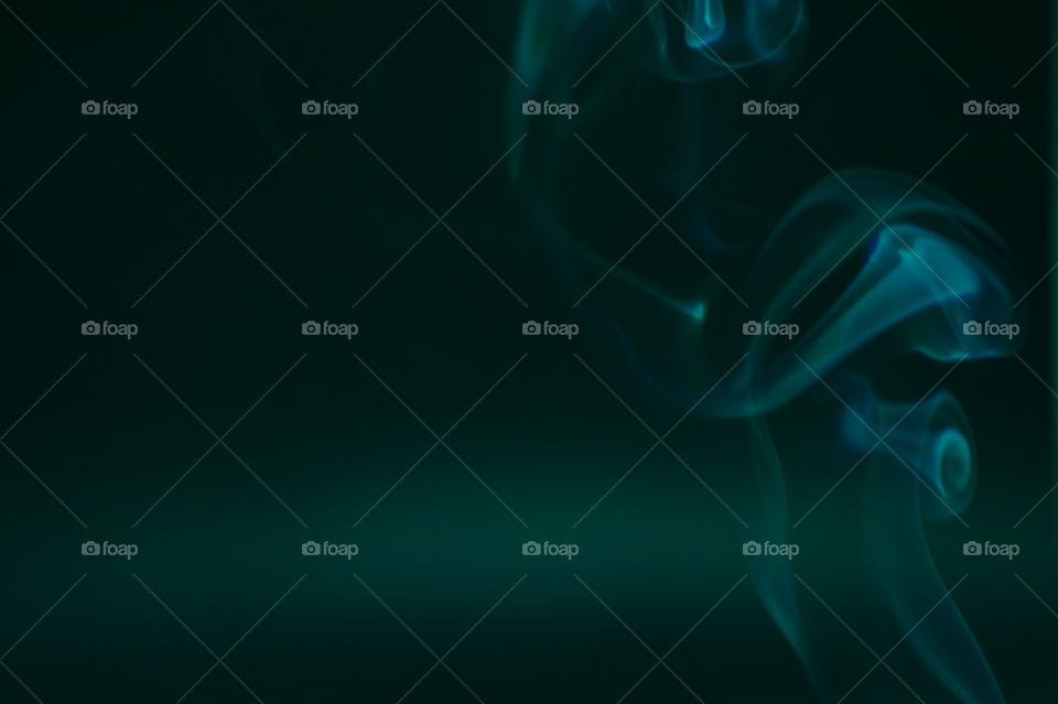 Smoke scented candles on a black background