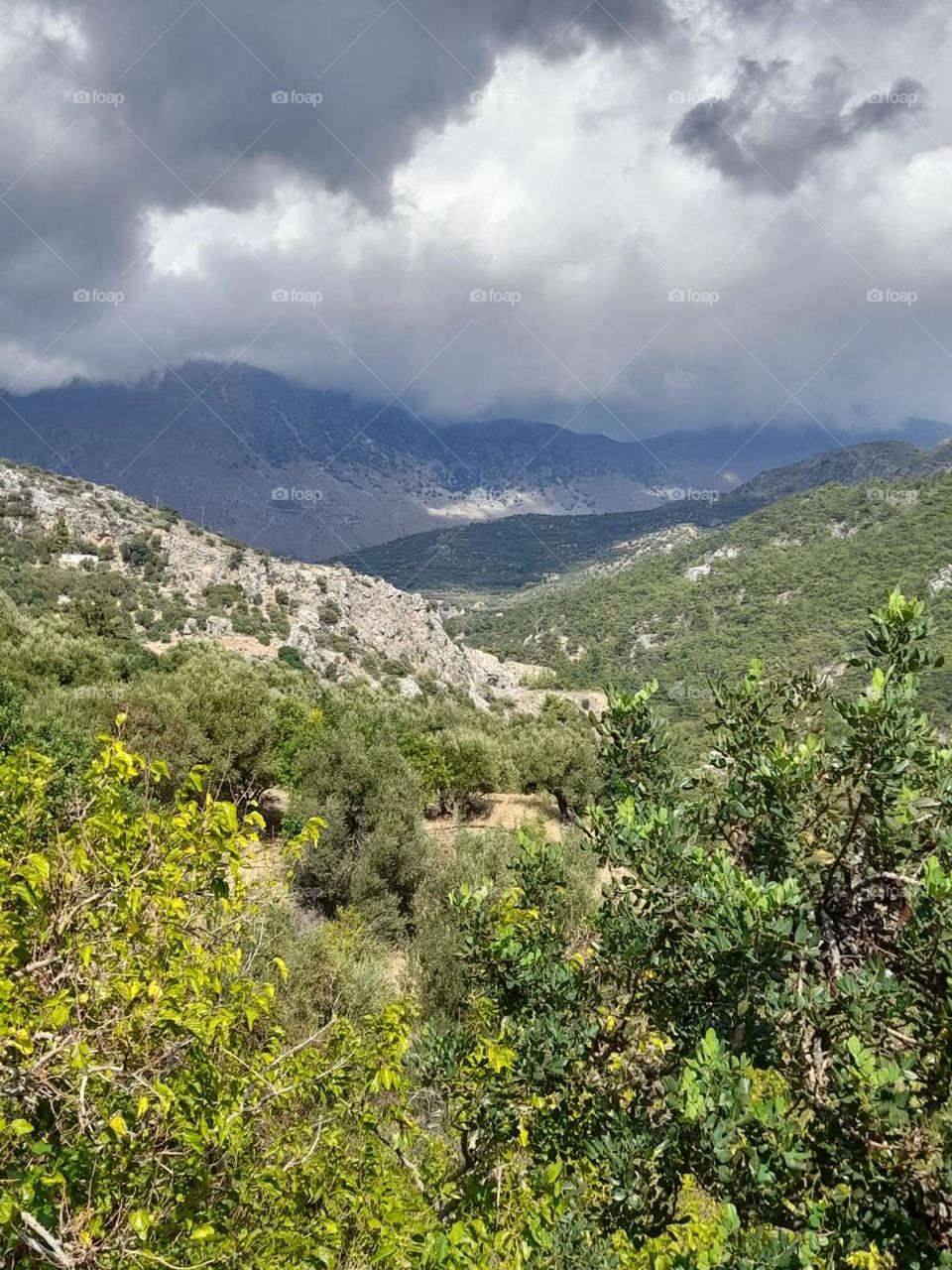 Greece. mpuntains. moody cloud in sky. green and rain filled clouds. atmospheric