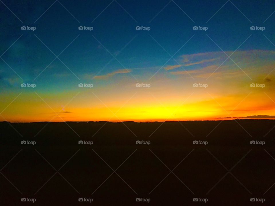 As the blazing orange sun meets up with the dazzling blue sky for a morning gather. 