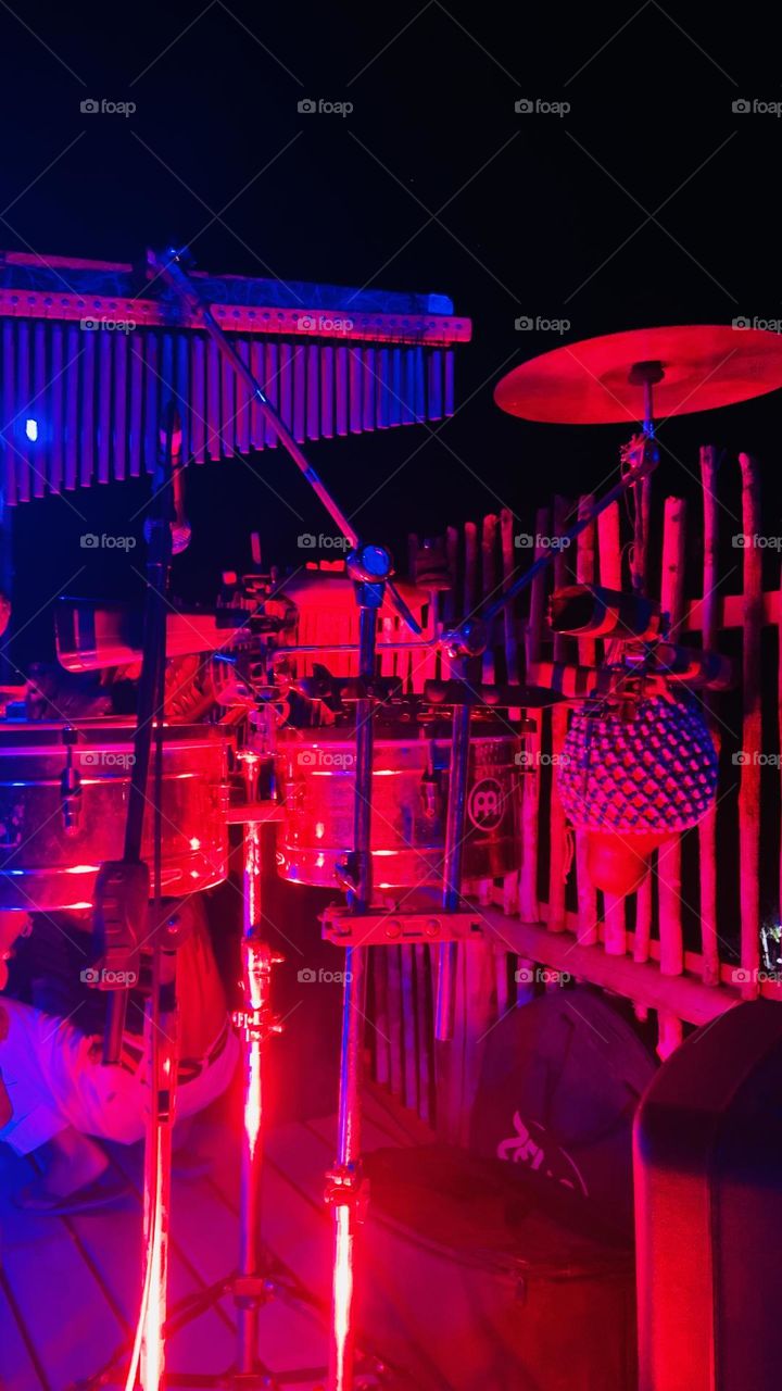 Drums and instruments at red magenta light 
