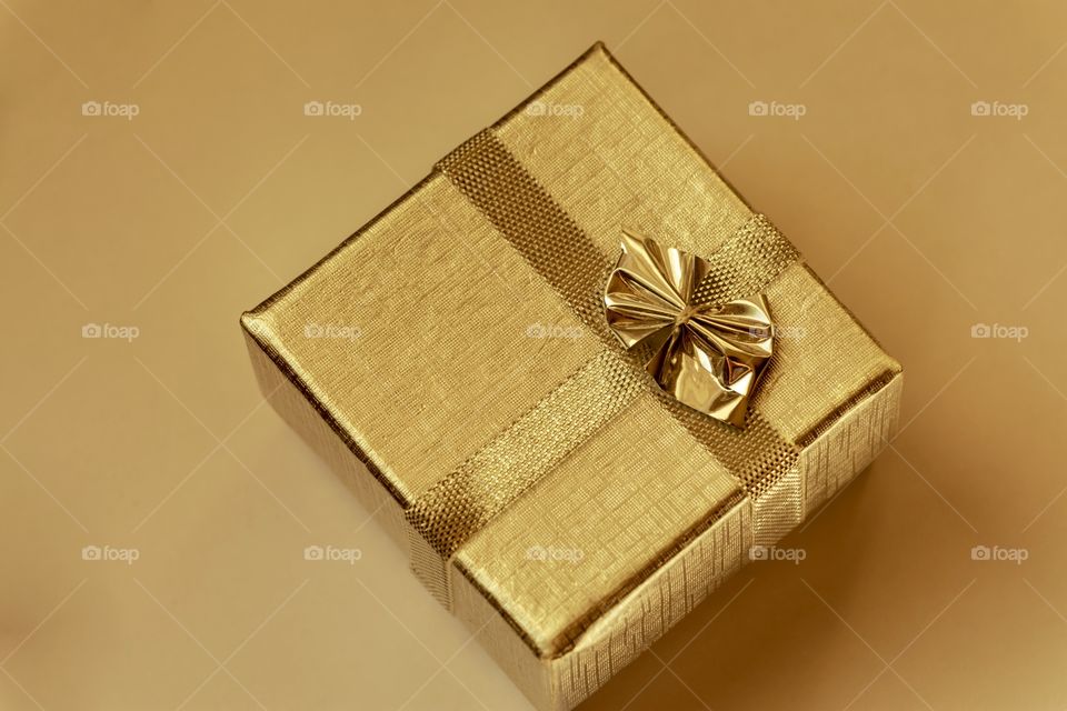 Golden box with golden ribbon