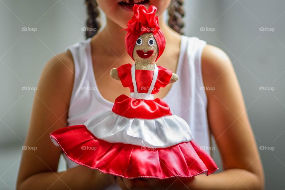 Little girl is holding homemade doll