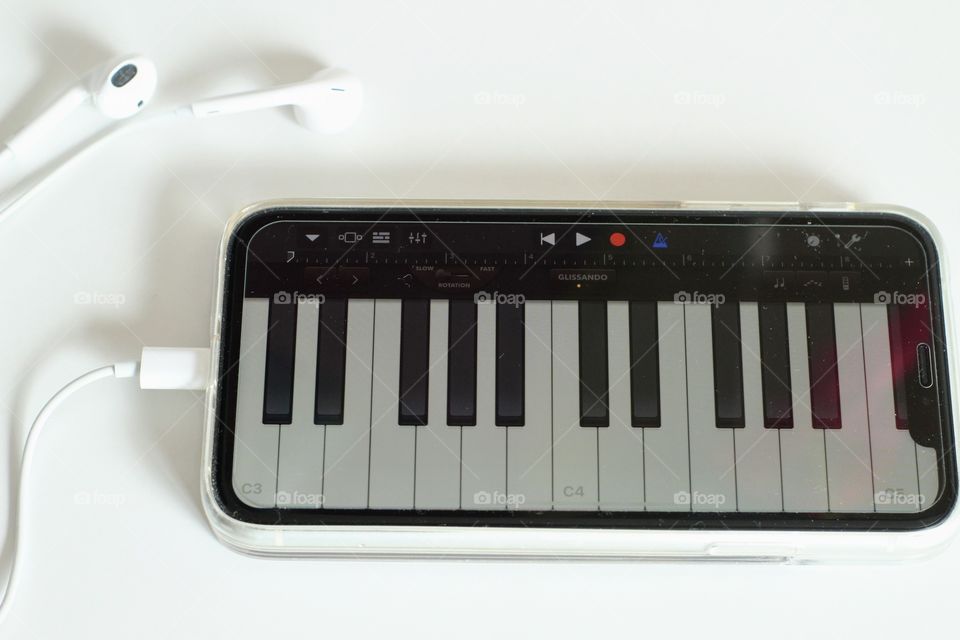 Playing piano on cellphone by GarageBand