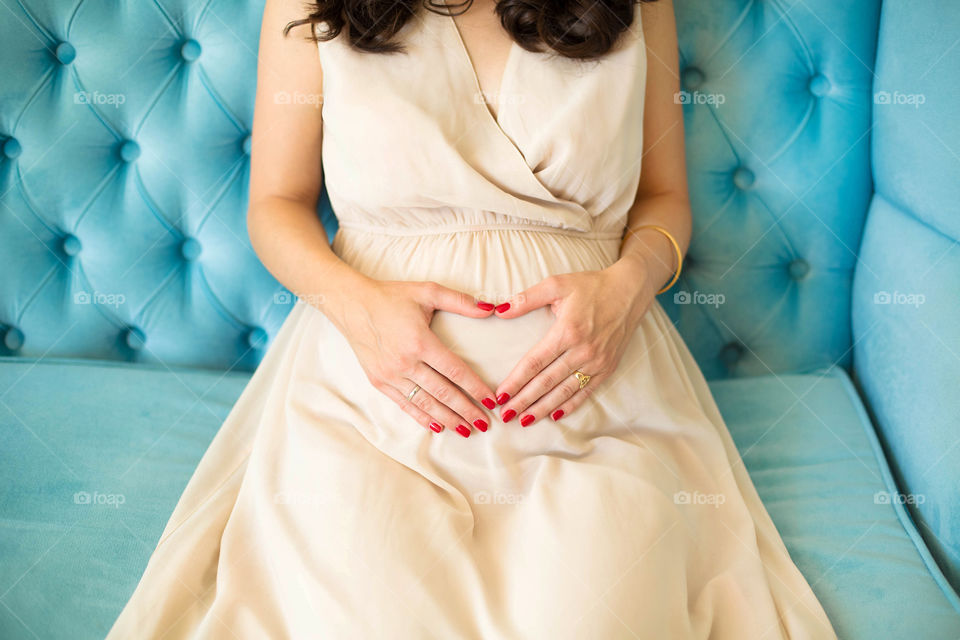 Pregnant woman sitting on sofa