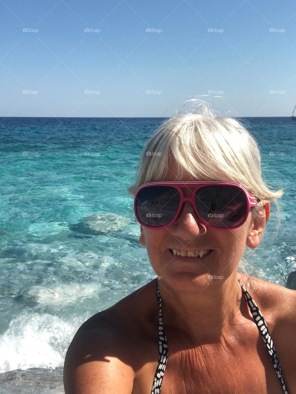 Energetic, vibrant, light hearted, female, portrait, happy, smiling, sunglasses, sea, healthy