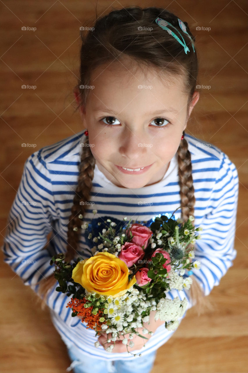 Young girl holding a bouquet of flowers