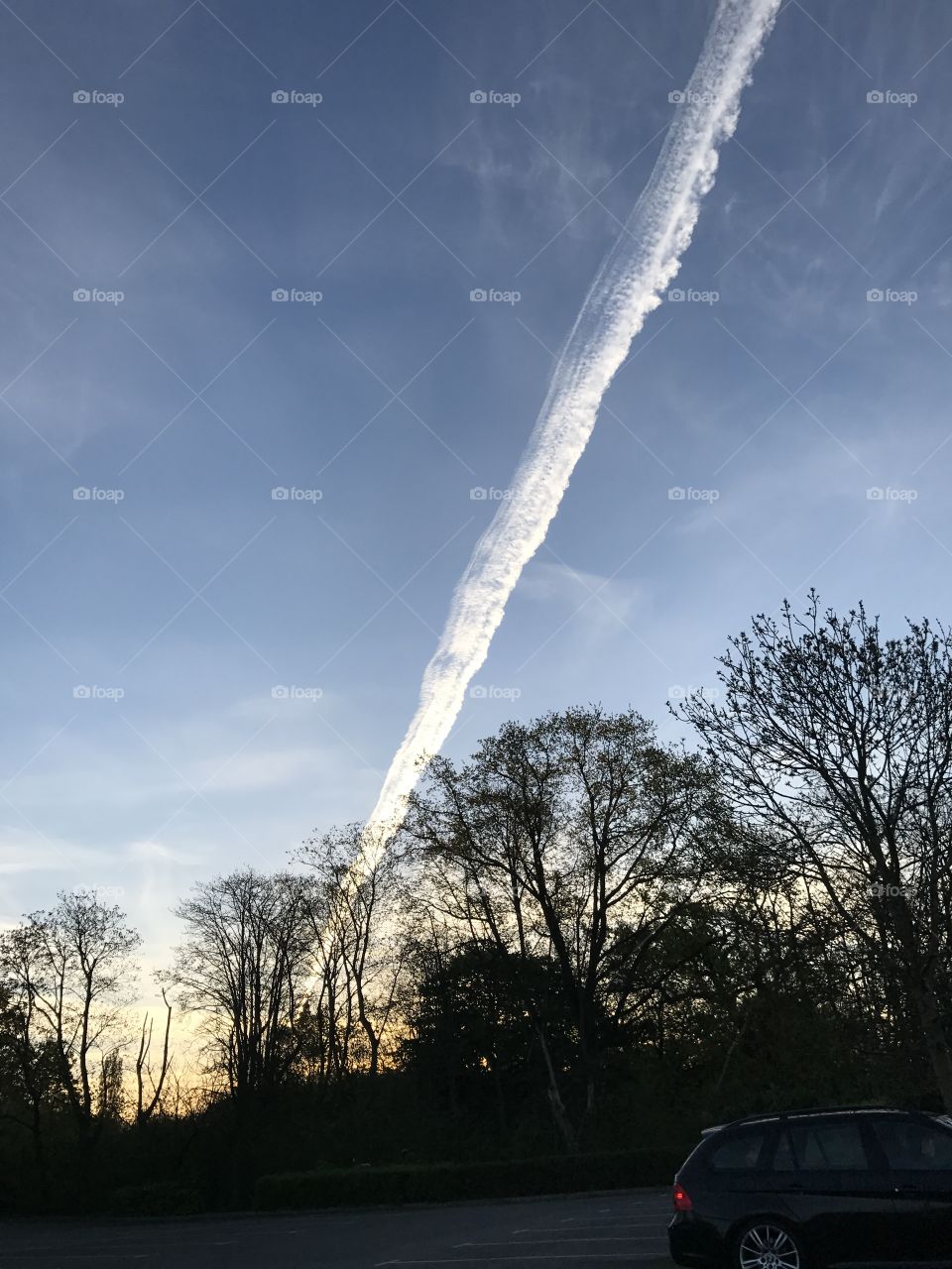 sky with airplane trails in the clouds 