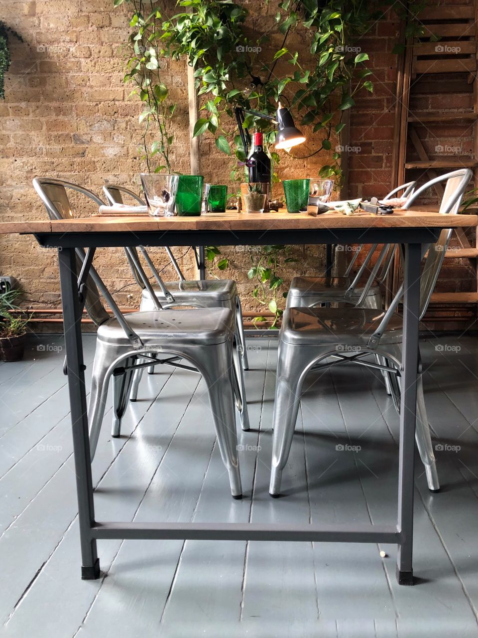 Dinner table with place settings in loft style interior