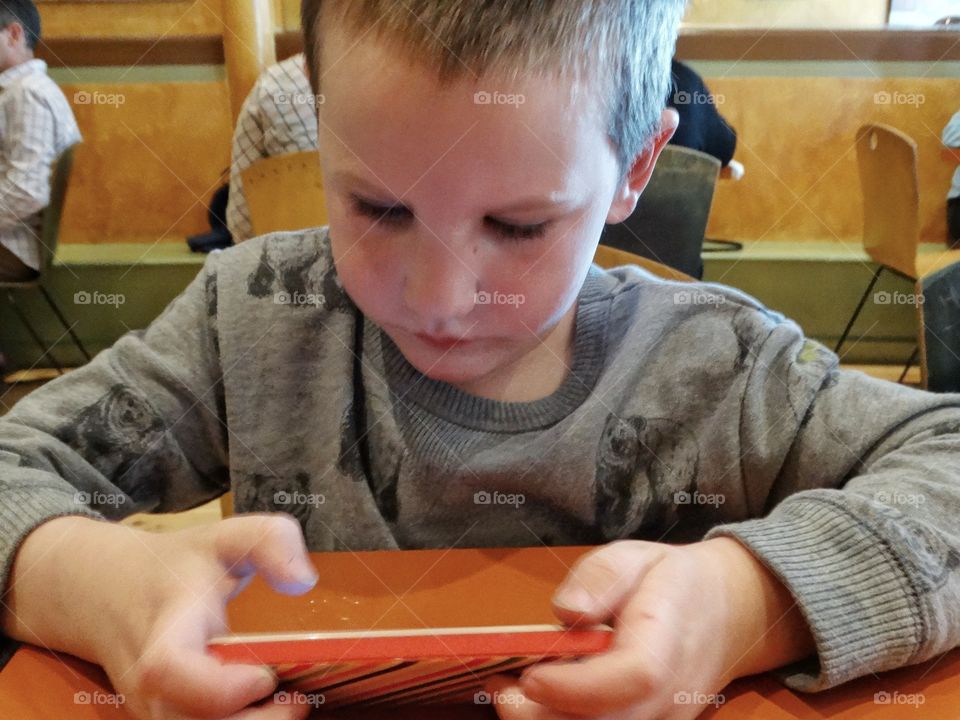 Child Playing With A Smartphone
