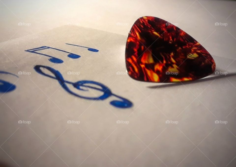 Guitar Pick With Music Notes